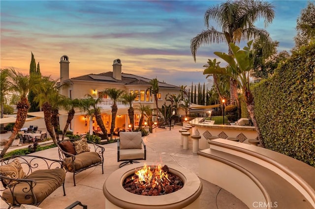 patio terrace at dusk with an outdoor fire pit