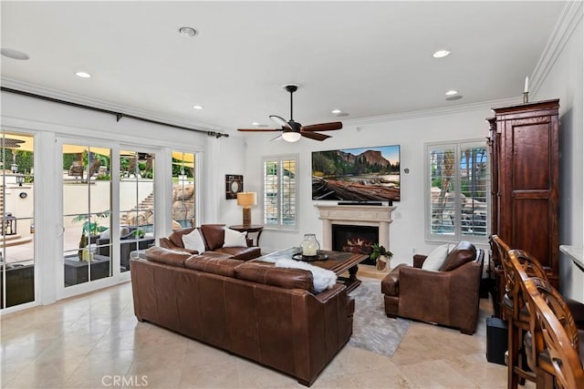 living room with crown molding, light tile patterned floors, and ceiling fan