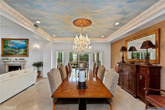 dining room featuring a chandelier and a raised ceiling