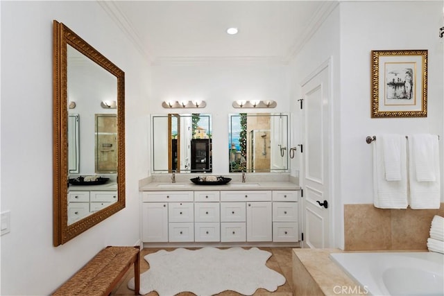 bathroom featuring crown molding, tile patterned floors, vanity, and a relaxing tiled tub