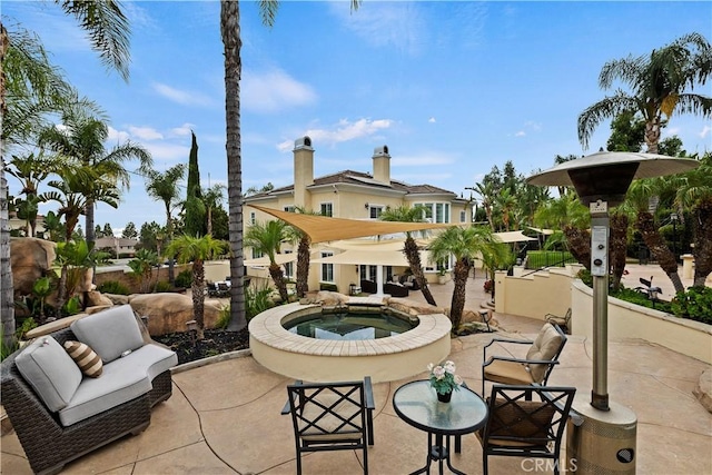 view of patio with an in ground hot tub and outdoor lounge area