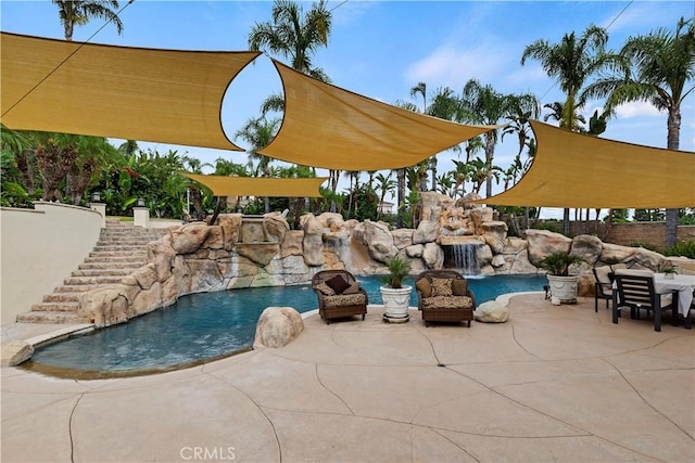 view of swimming pool with a patio and pool water feature