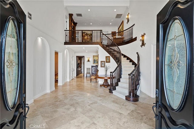 foyer featuring a towering ceiling