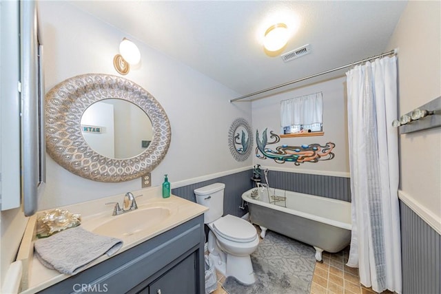 bathroom featuring a tub, vanity, and toilet