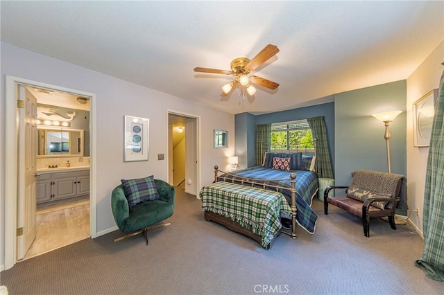 bedroom featuring carpet flooring, ensuite bathroom, and ceiling fan