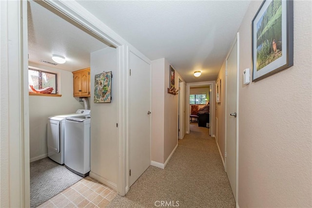 hallway with independent washer and dryer