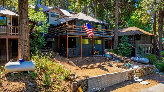 back of house with a wooden deck