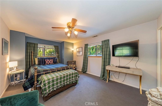 bedroom featuring carpet flooring, multiple windows, and ceiling fan