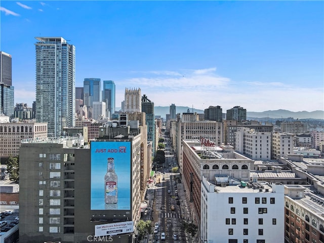 property's view of city featuring a mountain view