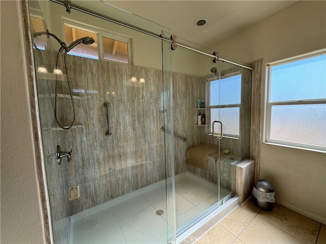 bathroom with tile patterned floors and a shower with shower door