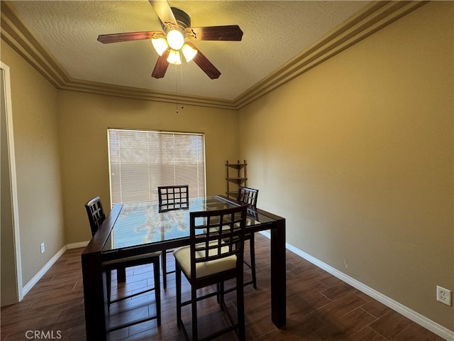 dining area featuring dark hardwood / wood-style flooring, a textured ceiling, ceiling fan, and crown molding