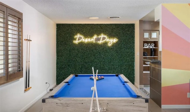 recreation room with a textured ceiling and pool table