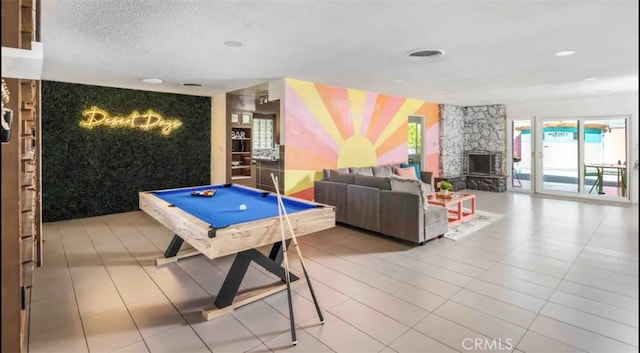 game room with a textured ceiling, tile patterned floors, and pool table