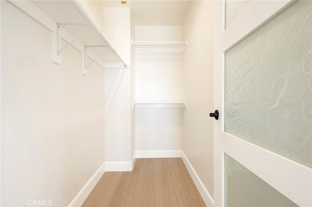 walk in closet featuring wood finished floors