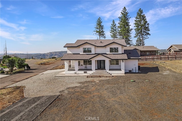 modern inspired farmhouse with fence and stucco siding