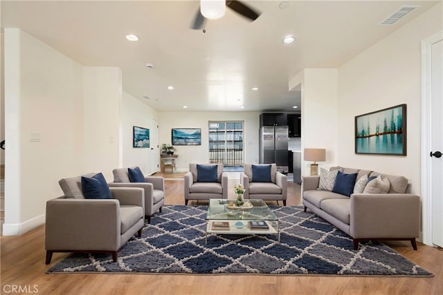 living room featuring recessed lighting, visible vents, and wood finished floors