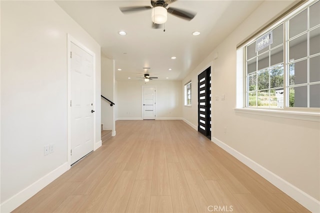 interior space with baseboards, stairway, recessed lighting, light wood-style floors, and a ceiling fan