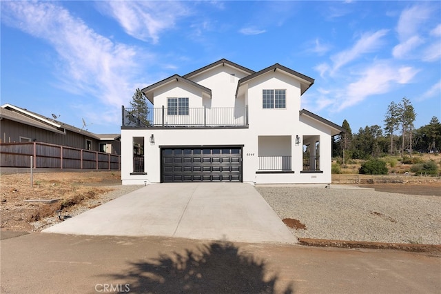 modern farmhouse style home with a balcony, driveway, a porch, an attached garage, and stucco siding