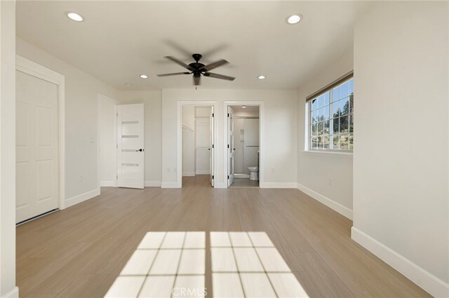 unfurnished bedroom featuring recessed lighting, wood finished floors, and baseboards