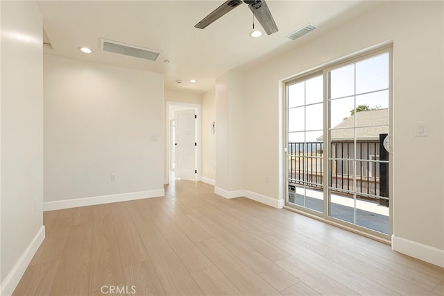 spare room featuring light wood-type flooring, visible vents, baseboards, and recessed lighting