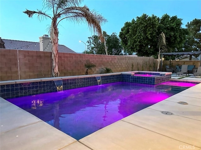 view of swimming pool with pool water feature, an in ground hot tub, and a patio area