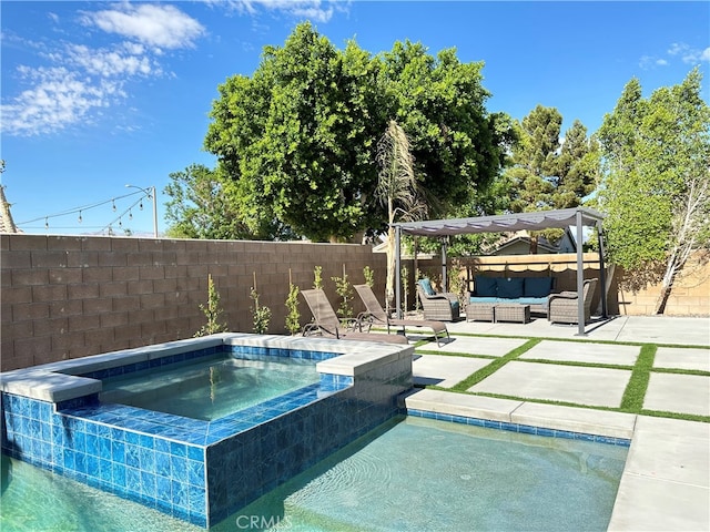 view of pool featuring an outdoor living space, an in ground hot tub, and a patio area