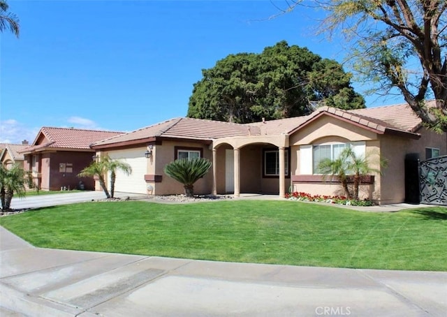 view of front of property with a front lawn and a garage