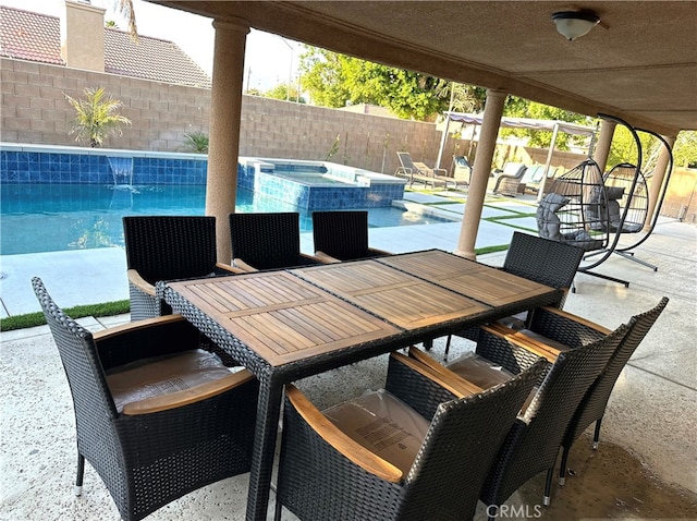 view of patio featuring a swimming pool with hot tub