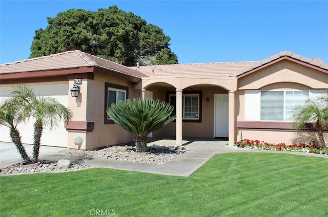 ranch-style house featuring a front yard and a garage