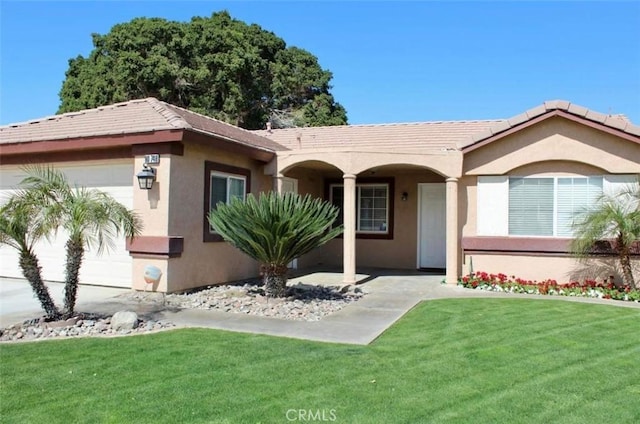 view of front of house with a garage and a front yard