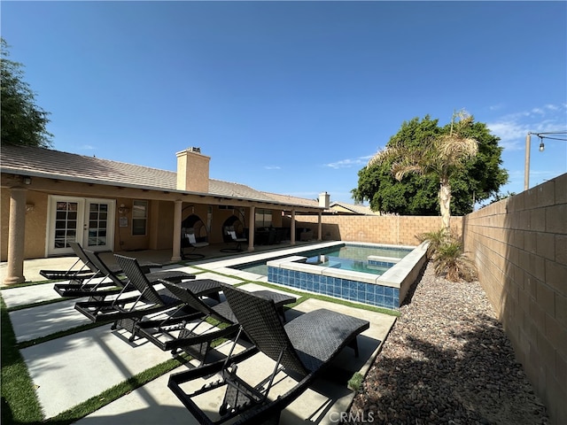 view of pool with a patio and an in ground hot tub