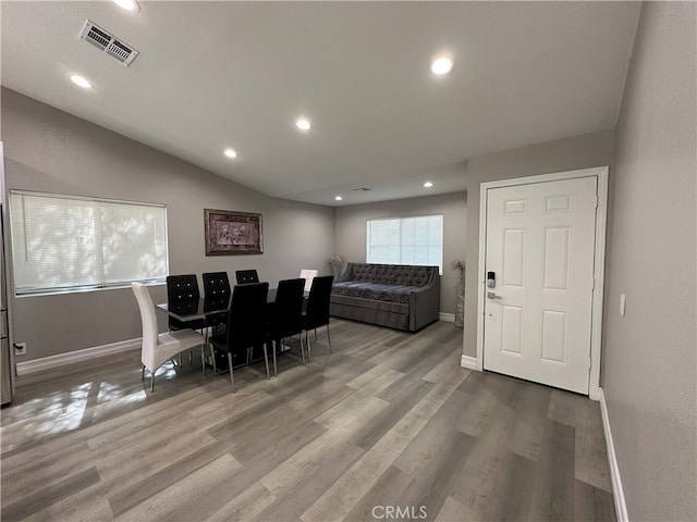 dining space featuring lofted ceiling and hardwood / wood-style floors