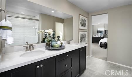 bathroom featuring a shower with door and vanity