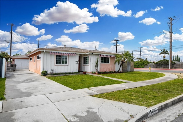 single story home featuring a garage and a front yard