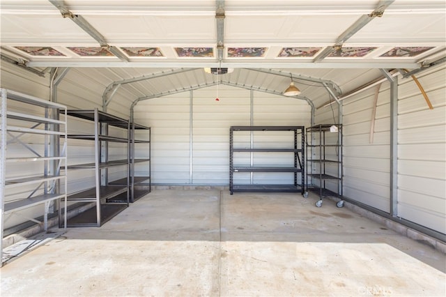 garage featuring metal wall and a garage door opener