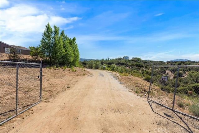 view of road with a gated entry