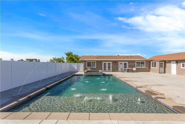 view of pool with a patio and pool water feature