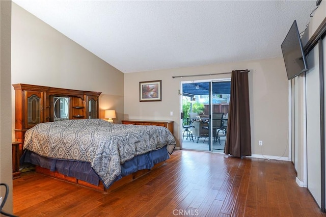 bedroom featuring access to exterior, high vaulted ceiling, and dark wood-type flooring