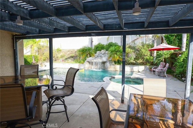 exterior space featuring pool water feature and a swimming pool with hot tub