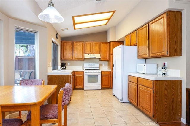 kitchen featuring white appliances, vaulted ceiling, sink, light tile patterned floors, and hanging light fixtures