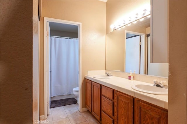 bathroom featuring tile patterned floors, a shower with curtain, vanity, and toilet