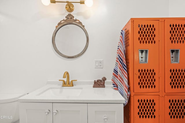 bathroom featuring vanity and toilet