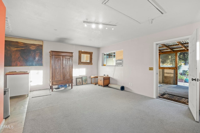 misc room with light colored carpet and rail lighting