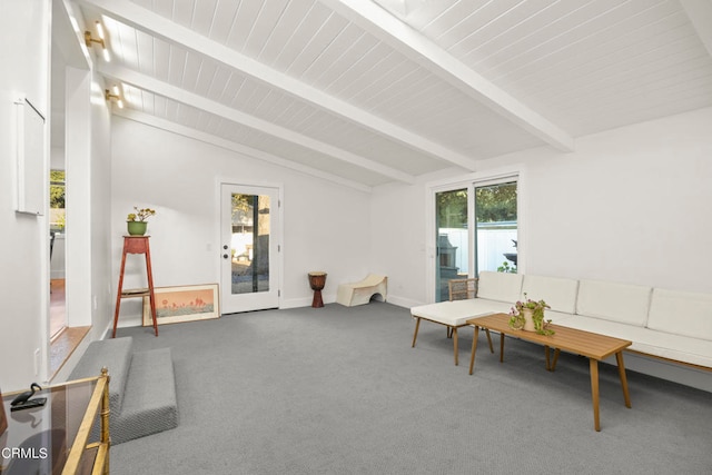 carpeted living room featuring vaulted ceiling with beams and a healthy amount of sunlight