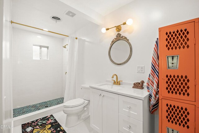 bathroom featuring tile patterned flooring, vanity, toilet, and a shower with shower curtain