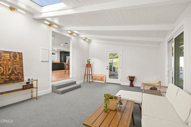 carpeted living room featuring lofted ceiling with skylight