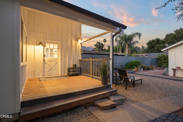 deck at dusk featuring a patio