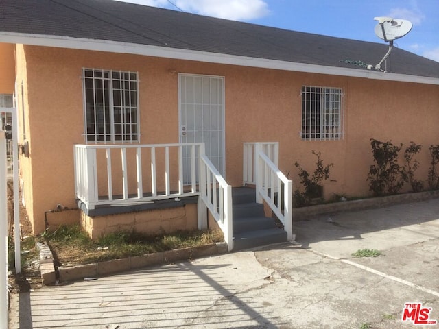 view of exterior entry with a patio