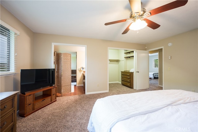 bedroom with ceiling fan, a closet, and light carpet