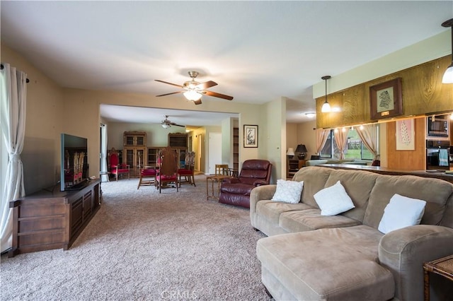 living room with carpet flooring and ceiling fan